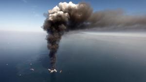 FILE - Wednesday, April 21, 2010: Oil can be seen in the Gulf of Mexico, more than 50 miles southeast of Louisiana's tip, from fires on BP's Deepwater Horizon offshore oil rig. (Gerald Herbert, File)