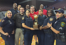 Cruz poses with Officers that provided security during the game; (Photo: Chris Daigle)